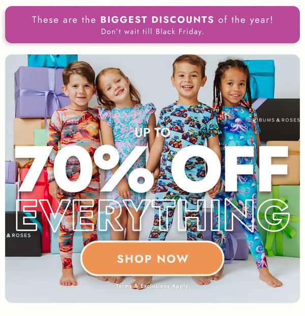 Four children in colorful patterned long-sleeve pajamas (truck, octopus, floral, sunset print) standing with gift boxes to announce up to 70% off everything on the store.