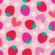 Pattern of red strawberries and red hearts on a pink background with small yellow and white stars.