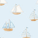 Pattern of various sailboats on a light blue background